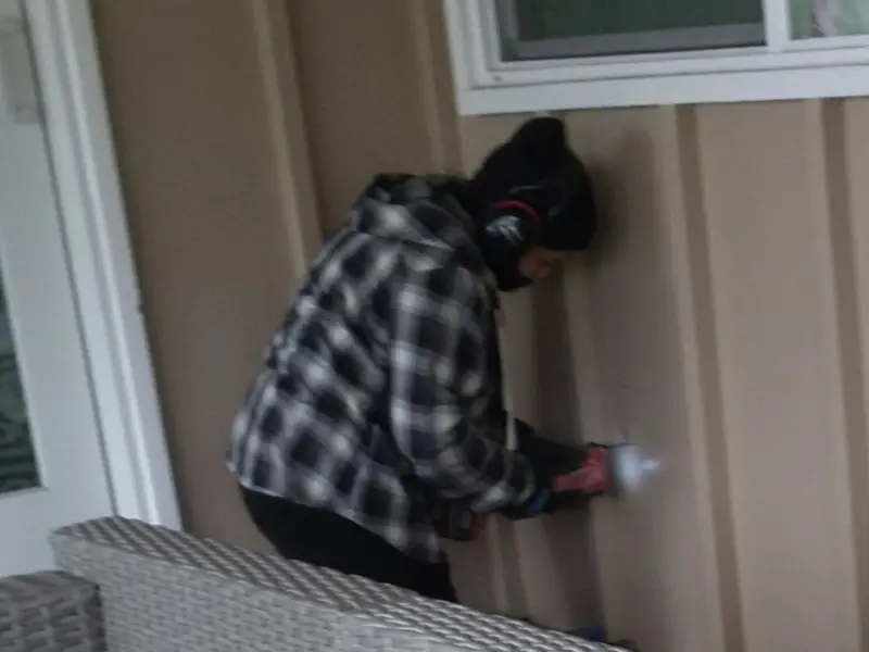 Professional electrician installing an exterior outlet in Jennings